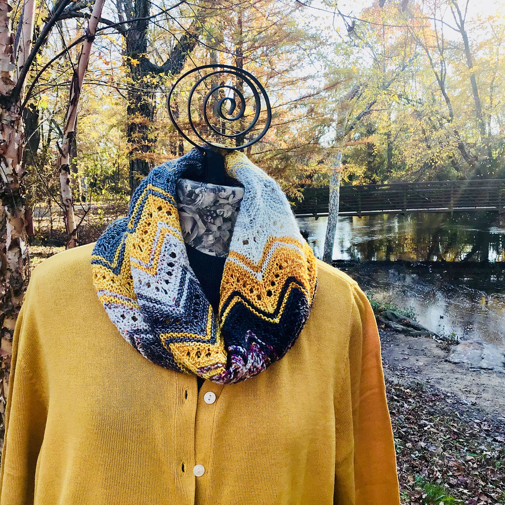 Knitted "Adventurer" cowl in gold, grey & black colors on mannequin in park