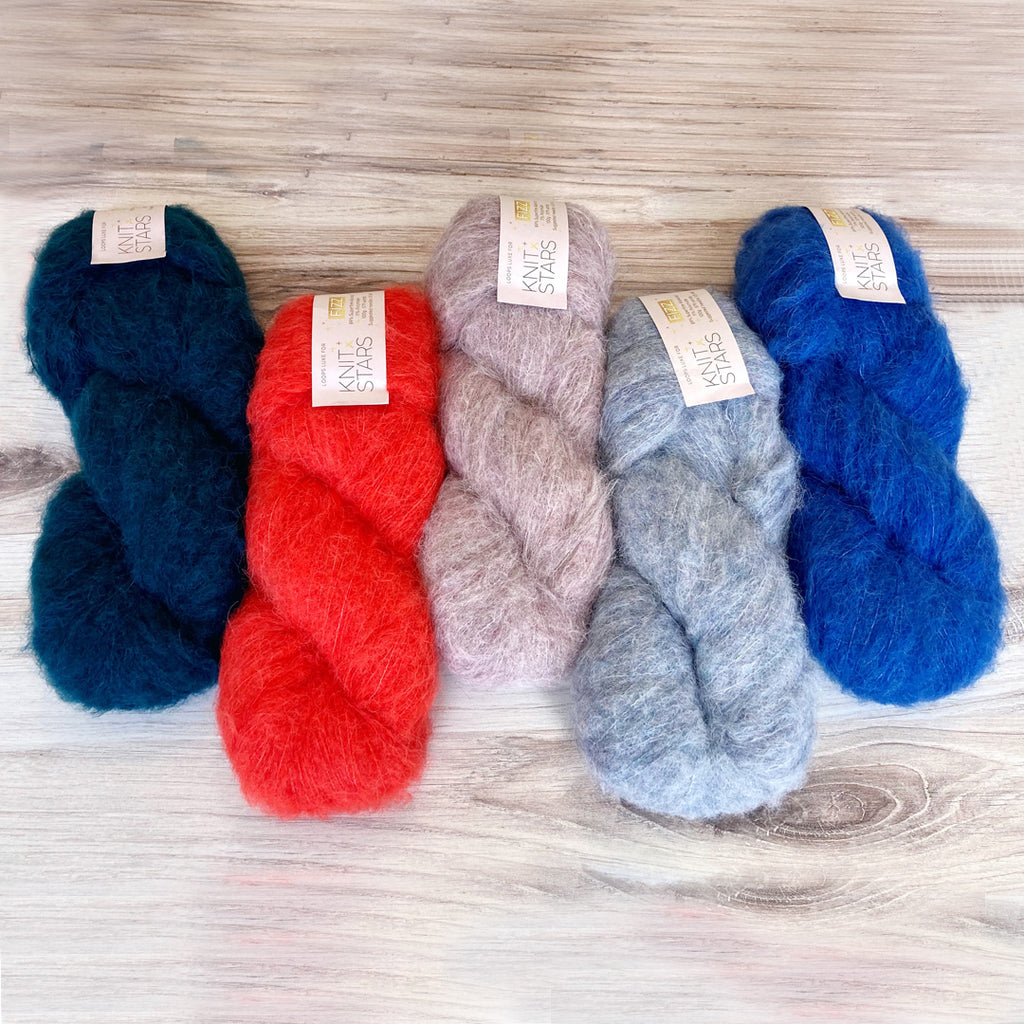 Assortment of Loops Luxe Fizz yarn on table